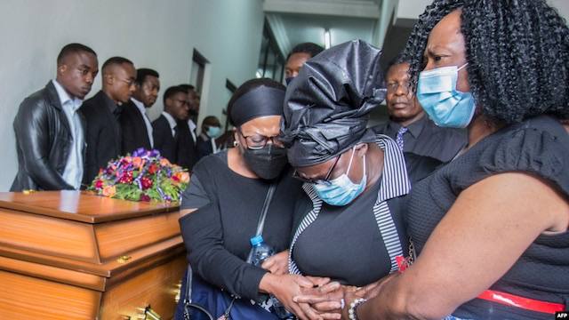 Burial of man in brown suit